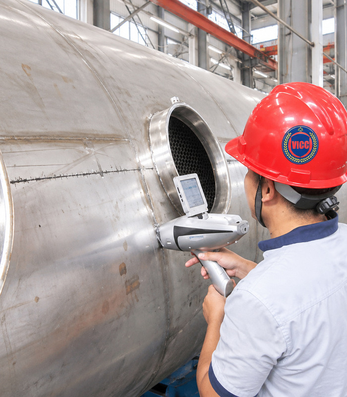 VICC inspector performing XRF material testing on industrial tank